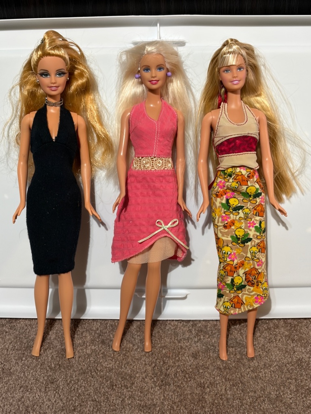 Three Fashion Dolls with Pink, Black, and Floral Dresses